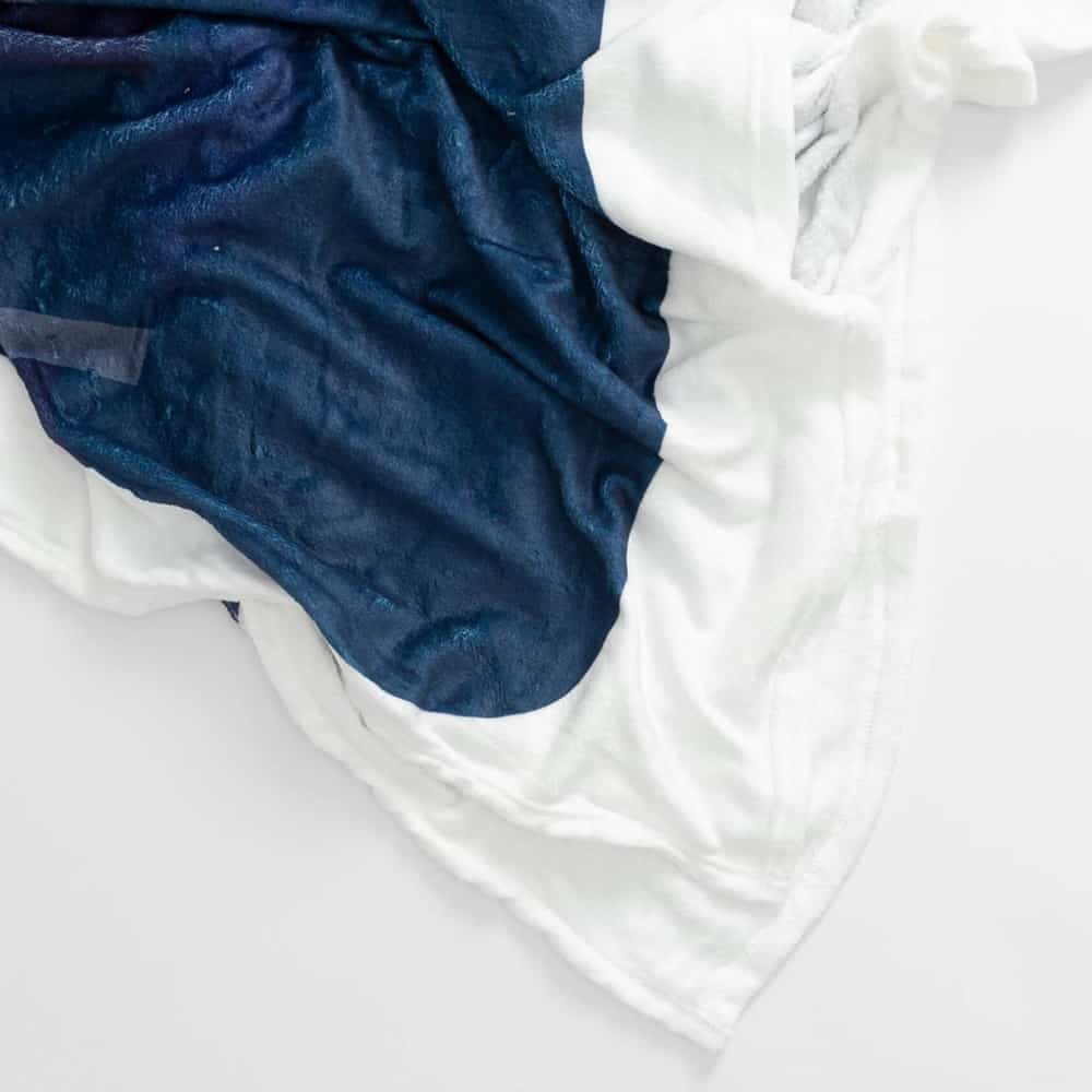 Skier going off cliff Fleece Throw Blanket