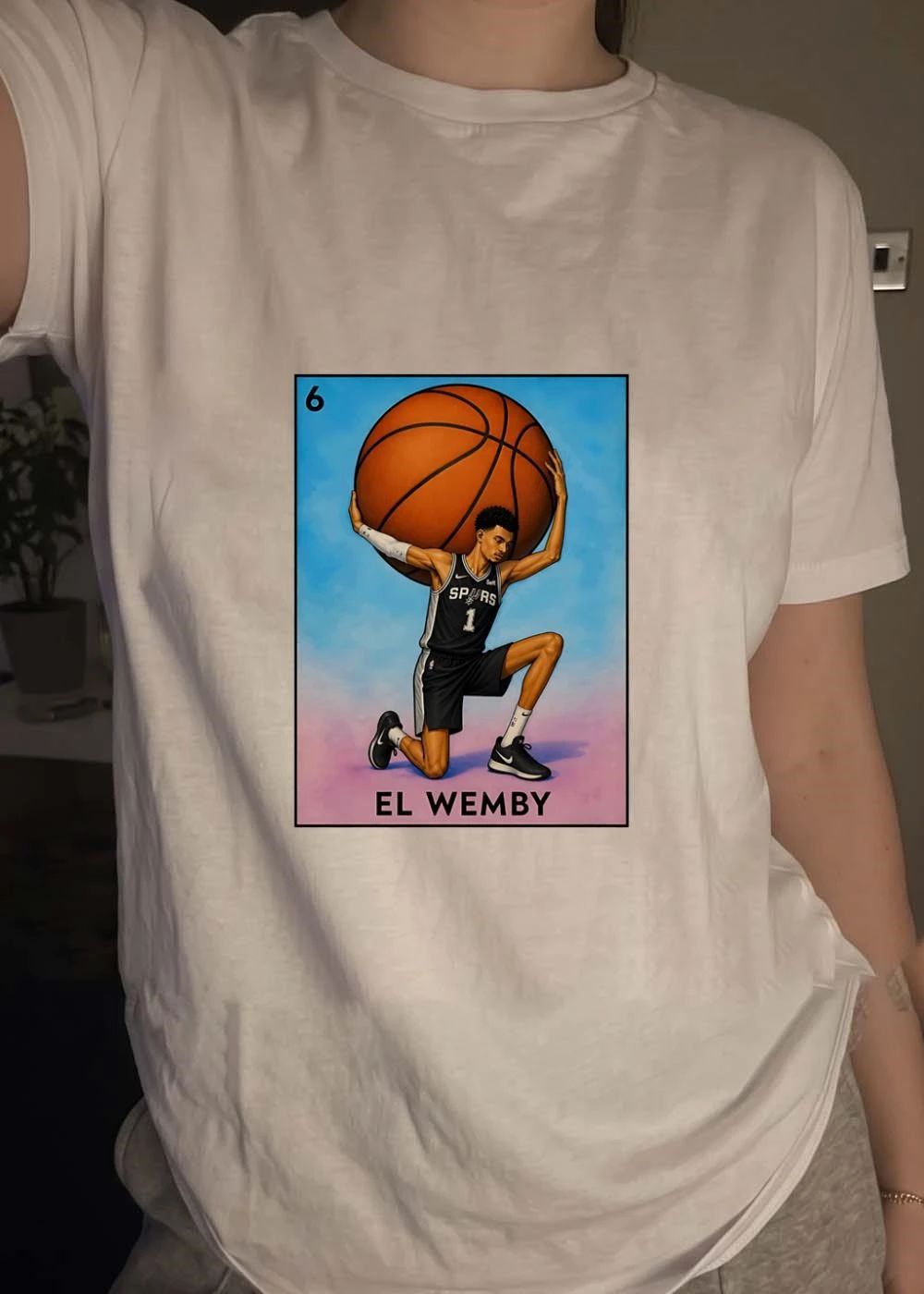 Lotería Style Victor Wembanyama Atlas Holding Basketball El Wemby Spurs T-Shirt