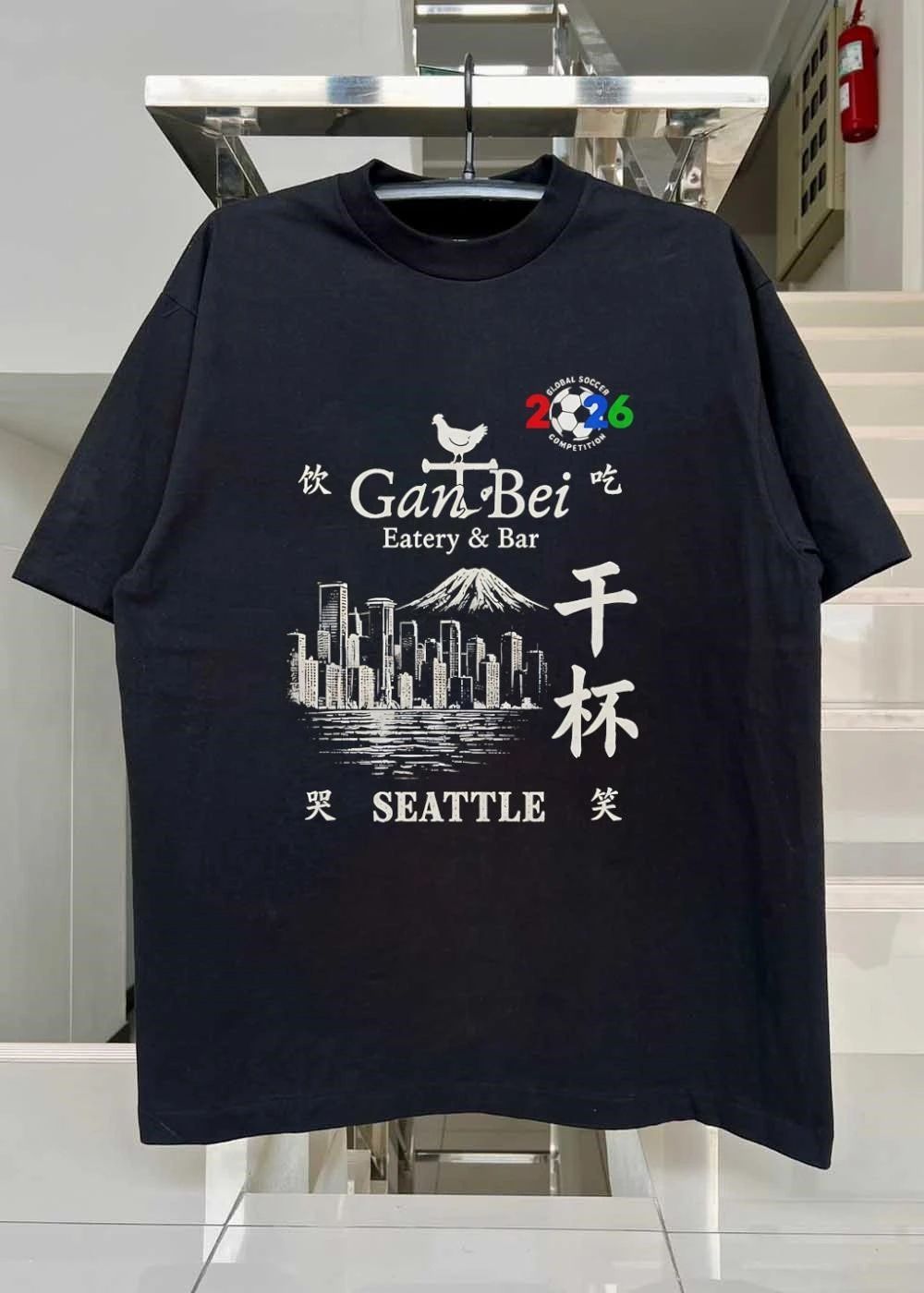 Gan Bei Seattle Drink Eat Laugh Cry Eatery Bar Global Soccer Competition 2026 T-Shirt